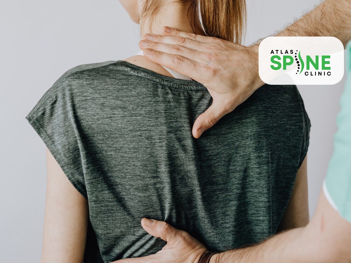 Chiropractor performing a hands-on back assessment at a first visit in Scarborough