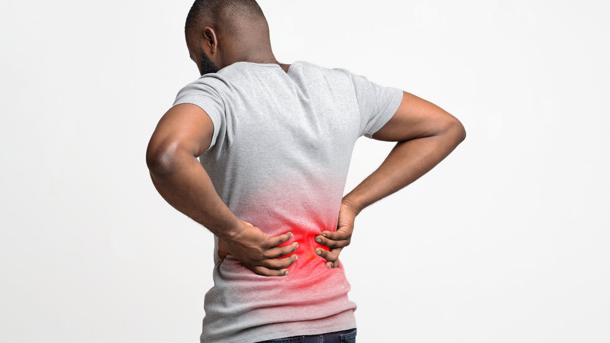 Man in Scarborough holding his lower back in pain from sciatica