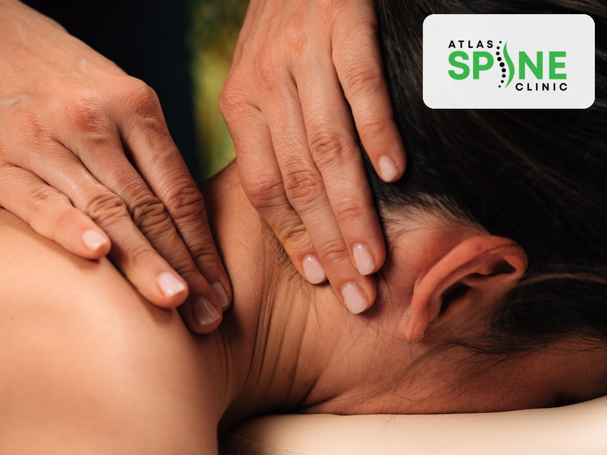 Close-up of a therapist applying trigger point pressure to a patient's neck and shoulder