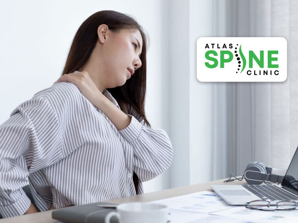 Office worker in Scarborough holding a stiff, painful neck from desk and laptop use