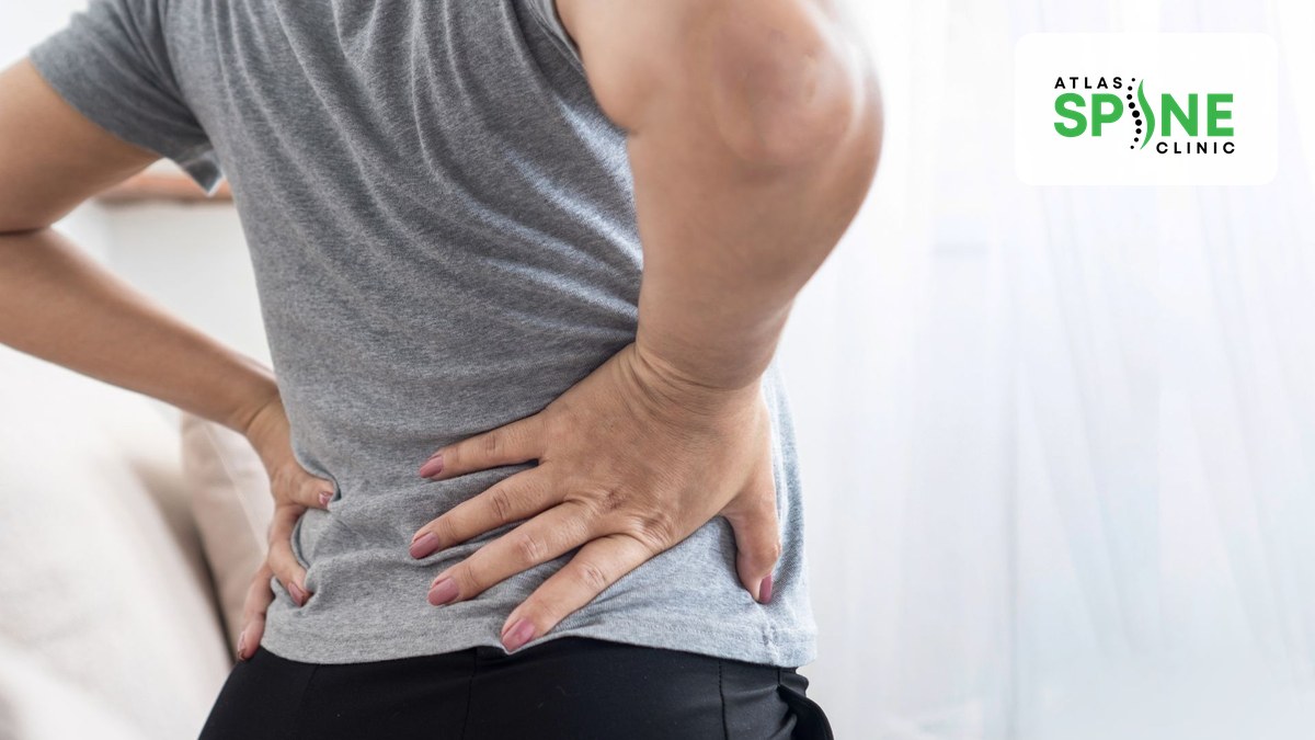 Close-up of a person holding their lower back with herniated disc pain in Scarborough