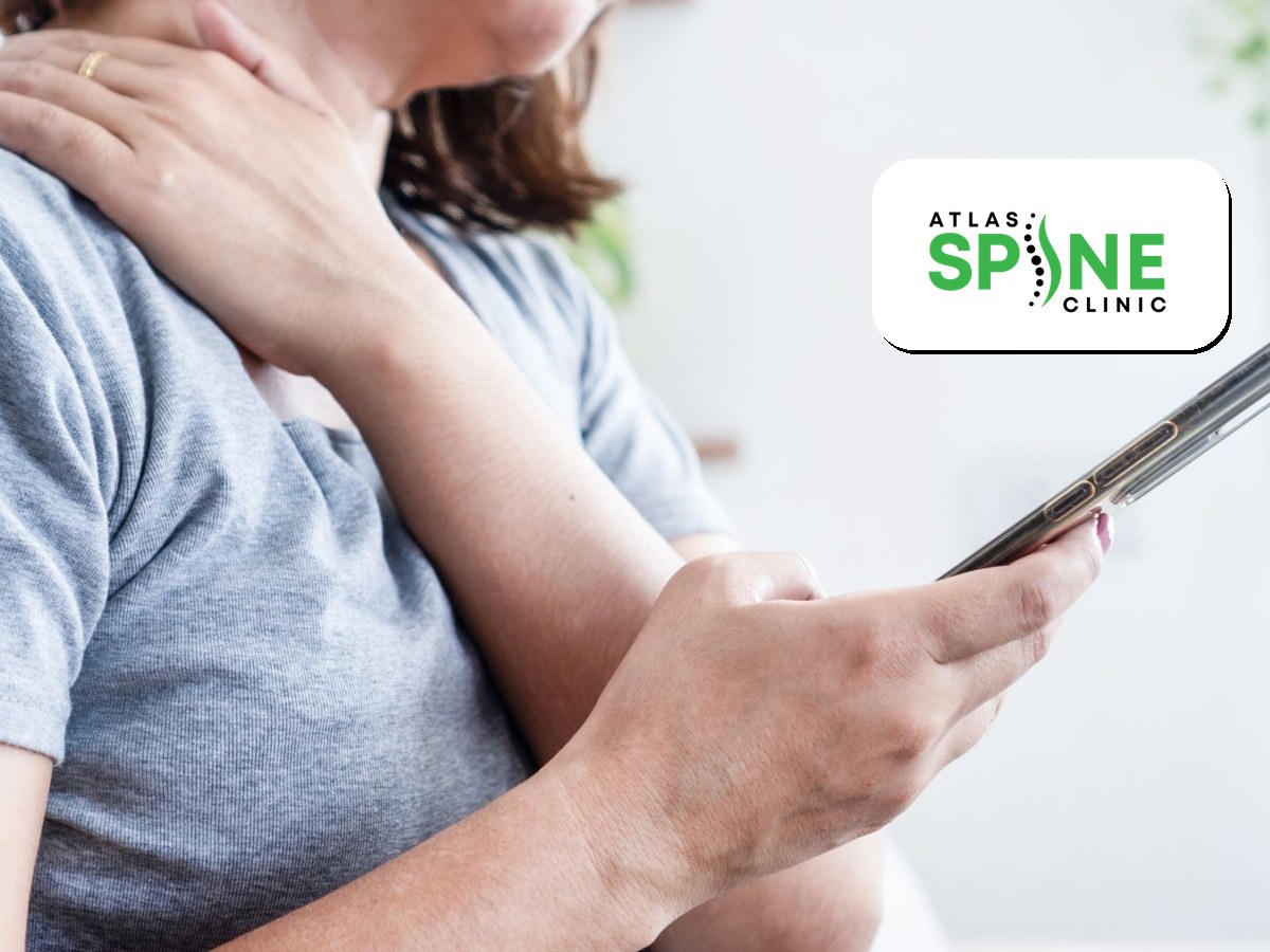 Person holding a phone and rubbing a sore neck, a sign of text neck